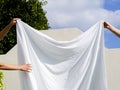 close up two people hanging white sheet line. High quality photo Royalty Free Stock Photo