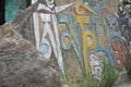 Om Mani Padme Hum Buddhist mantra written Tibetan script on rock in Rewalsar lake Tso Pema, Himachal Pradesh, India Royalty Free Stock Photo