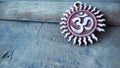 Om pendent on wood background and greeting