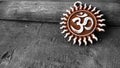 Om pendent on wood background and greeting