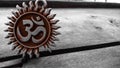 Om pendent on wood background and greeting