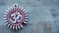 Om pendent on wood background and greeting