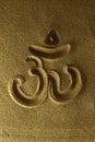 Om symbol hand drawn in the sand
