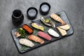 omakase mixed sushi set with sake on grey background Royalty Free Stock Photo