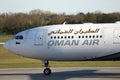 Oman Air taxiing on runway Royalty Free Stock Photo