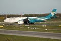 Oman Air taxiing on runway Royalty Free Stock Photo