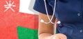 Oman flag female doctor with stethoscope