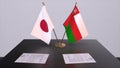 Oman and Japan national flags, political deal, diplomatic meeting. Politics and business 3D illustration