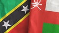 Oman and Saint Kitts and Nevis two flags textile cloth 3D rendering