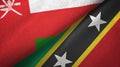 Oman and Saint Kitts and Nevis two flags textile cloth, fabric texture