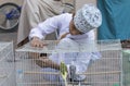 omani boy with a bird cage