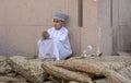 Omani boy in traditional clothing at a market