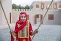 omani girl in traditional clothing on a swing