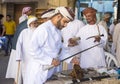 Omani man buying a sword