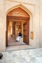 Omani man at Entrance to the Jabreen Castle in Bahla, Sultanate of Oman Royalty Free Stock Photo