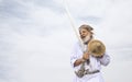 Omani man in traditional clothing singling and dancing with his sword Royalty Free Stock Photo