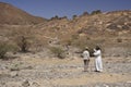 Tourists and guide at Al-Ayn beehive tombs, Oman