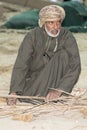 Omani man weaving palm leaves