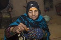 Omani woman making traditional bracelets