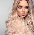 Ombre blond hairstyle. Beauty fashion blonde portrait. Sexy woman wears in pink fur coat. Beautiful girl model with makeup, long Royalty Free Stock Photo