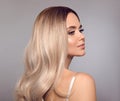 Ombre blond shiny hair. Beauty fashion blonde woman portrait. Beautiful girl model with makeup, long healthy hairstyle posing Royalty Free Stock Photo