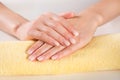 Ombre manicure on woman gently hands on yellow towel