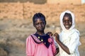 girls pose for a photo in their best clothes in Omdourman near Khartoum, Sudan