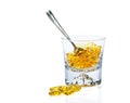 Omega-3 vitamins in glass and teaspoon