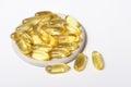 omega-3 capsules on a grey plate. fish oil for vascular health and heart support. essential supplement for healthy