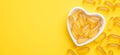 Omega 3 capsules in a heart-shaped plate on yellow background. Fish oil softgels. Supplement food vitamin D capsules Royalty Free Stock Photo