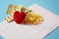 Omega-3 capsules lie on a cardiogram next to a red heart. Fish oil in tablets. Health support and heart treatment Royalty Free Stock Photo