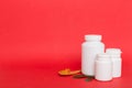 Omega-3 capsules lie in white bottle on a table with green leaves background. Fish oil tablets. Biologically active Royalty Free Stock Photo