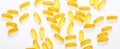 Omega 3 capsules on white background Fish oil Yellow softgels Vitamin D, E, A supplement Concept of healthcare Banner