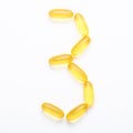 Omega 3 capsules on white background Fish oil Yellow softgels Vitamin D, E, A supplement Concept of healthcare Royalty Free Stock Photo