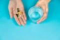 Omega 3 fish oil capsules spilling out of a bottle on a blue background. selective focus Royalty Free Stock Photo