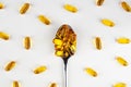 Omega 3 fish oil capsules on a spoon on a light background Royalty Free Stock Photo