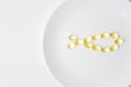 Omega-3 polyunsaturated fatty acids on a plate. Fish oil softgels on a white plate in a shape of a fish. Meal replacement. Casual
