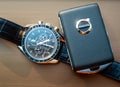 Omega Speedmaster 1866 with Volvo key fob in natural light