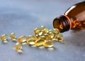 Omega 3 vitamins pills scattered from the bottle Royalty Free Stock Photo