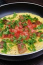 Omelet bacon slices, tomatoes with herbs