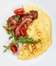 Omelet with bacon and tomatoes on white background Royalty Free Stock Photo
