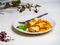 Omelet and canned vegetables on a light plate standing on a white table with a fork Royalty Free Stock Photo