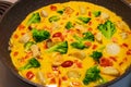 Omelet, cooking. Hot omelette with herbs, tomatoes and vegetables in a pan. Italian omelette with vegetables