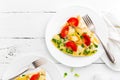 Omelet. Eggs fried. Scrambled eggs with green onion and fresh tomato. Omlette on white plate. Breakfast. Top view Royalty Free Stock Photo