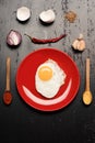 Omelet and eggshells, garlic, chili pepper and onion placed around Royalty Free Stock Photo