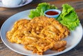 Omelet, fried beaten eggs with crab on white plate