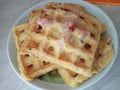 Omelet with ham and tomatoes cooked in a waffle iron.