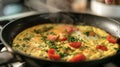 A omelet made with fresh tomatoes and herbs sizzling in a hot frying pan on the stove Royalty Free Stock Photo