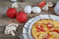 Omelet with onion, tomatoes and mushrooms