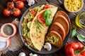 Omelet with pepper, tomato, corn, green onion, cucumber, mushrooms and fried bread Royalty Free Stock Photo